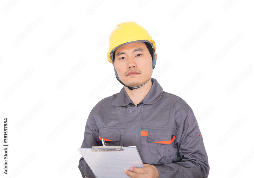 Worker wearing yellow hard hat in front of white background holds folder Worker wearing yellow hard hat in front of white background holds folder