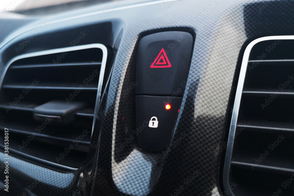 A car lock button and status light and emergency stop button in car interior