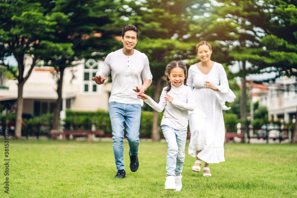 Portrait of enjoy happy love asian family father and mother with little asian girl smiling running playing and having fun moments good time in summer park at home Portrait of enjoy happy love asian family father and mother with little asian girl smiling running playing and having fun moments good time in summer park at home