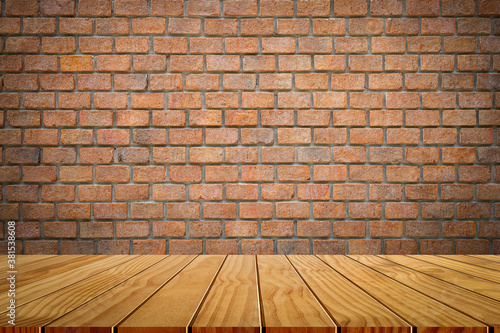 Wooden tabletop template mockup for display merchandise. wooden shelf table isolated on orange brick wall background.