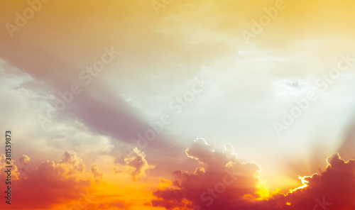 sky and clouds nature background,red light on clouds and bright yellow sun light on colorful sky © Passakorn