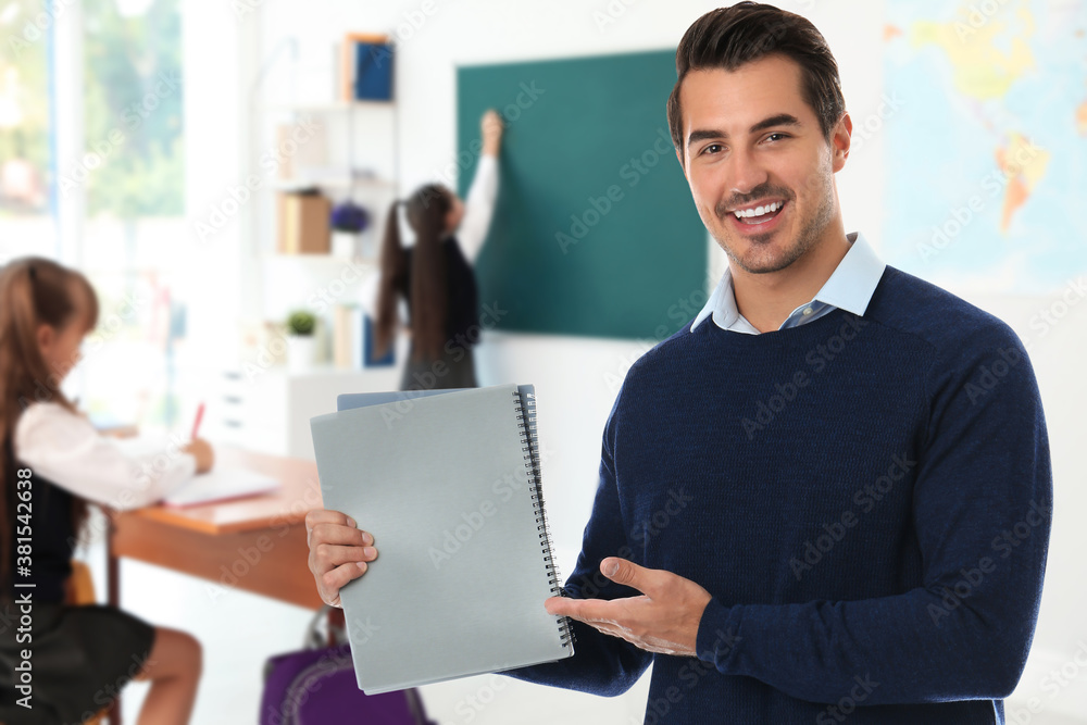 Young school teacher in classroom with students Young school teacher in classroom with students