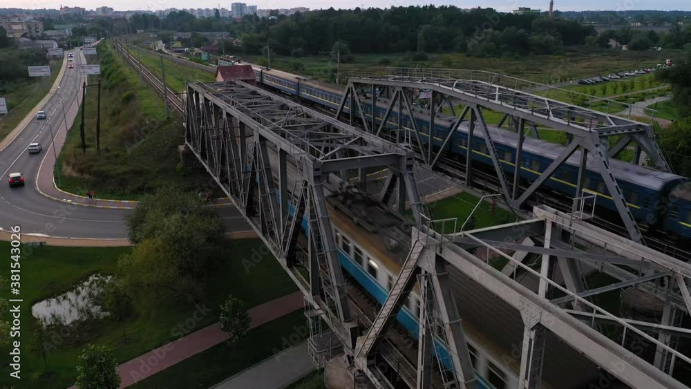 Drone view of two trains traveling opposite each other on a railway bridge. View from the camera rises smoothly. Drone view of two trains traveling opposite each other on a railway bridge. View from the camera rises smoothly.