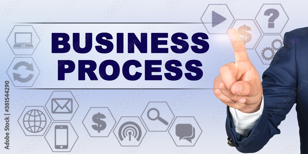 Businessman touching virtual screen with his finger. Screen caption - BUSINESS PROCESS Businessman touching virtual screen with his finger. Screen caption - BUSINESS PROCESS