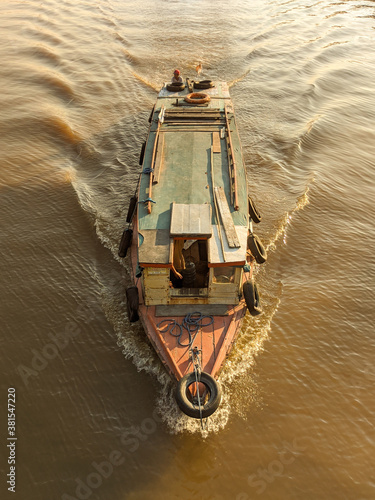 kentinting is traditional boat with wooden skin in the mahakam river photo