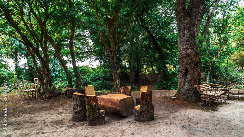 Picnic site with wooden table and benches in forest Picnic site with wooden table and benches in forest
