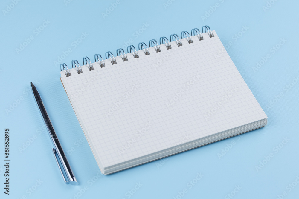 school notebook with pen on a blue table top view school notebook with pen on a blue table top view
