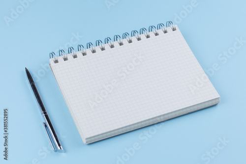 school notebook with pen on a blue table top view © alexxndr