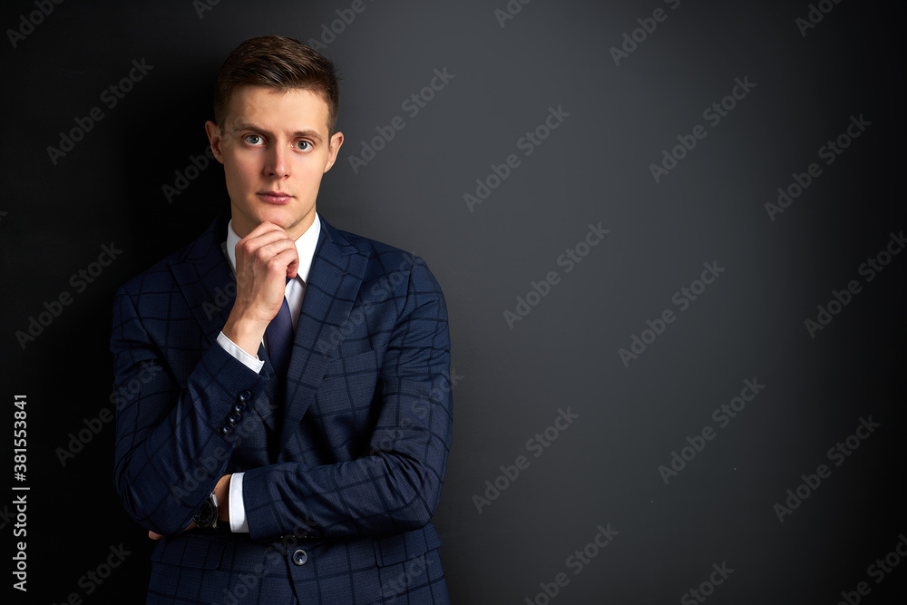 thoughtful caucasian guy in formal suit is in contemplation, worried male posing, studio shoot. people concept thoughtful caucasian guy in formal suit is in contemplation, worried male posing, studio shoot. people concept