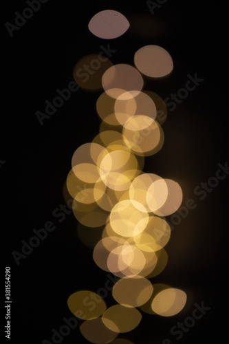 Gold sparkling bokeh on black background for texture or design. Copy space