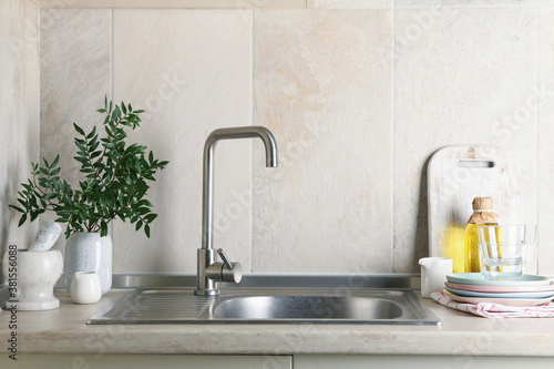 Kitchen interior with sink and different supplies photo