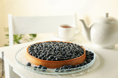 Concept of tasty breakfast with blueberry pie on white table