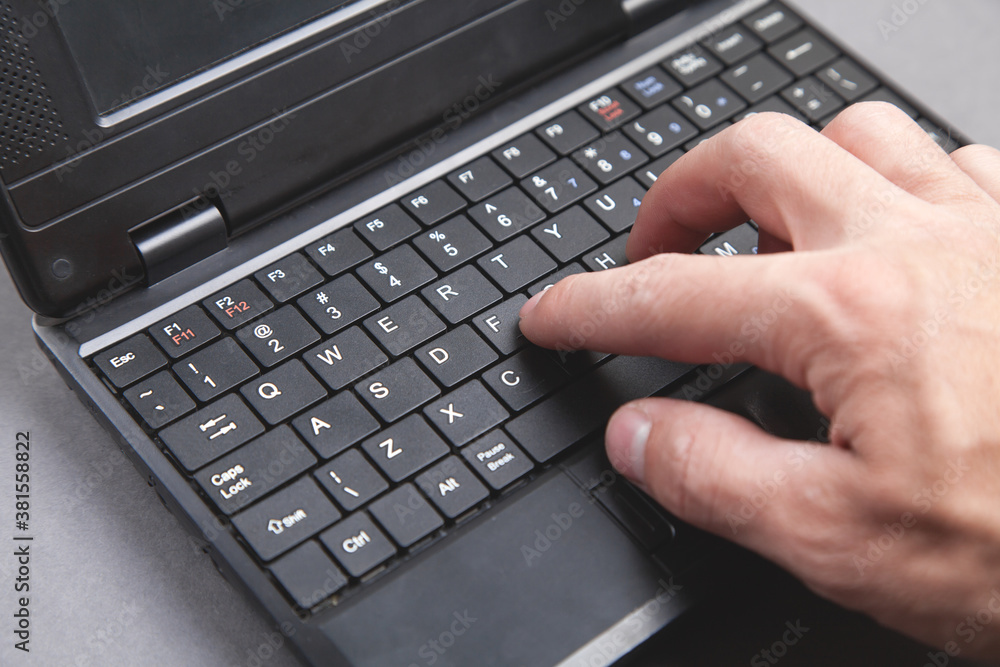 Male hand typing on computer keyboard. Male hand typing on computer keyboard.