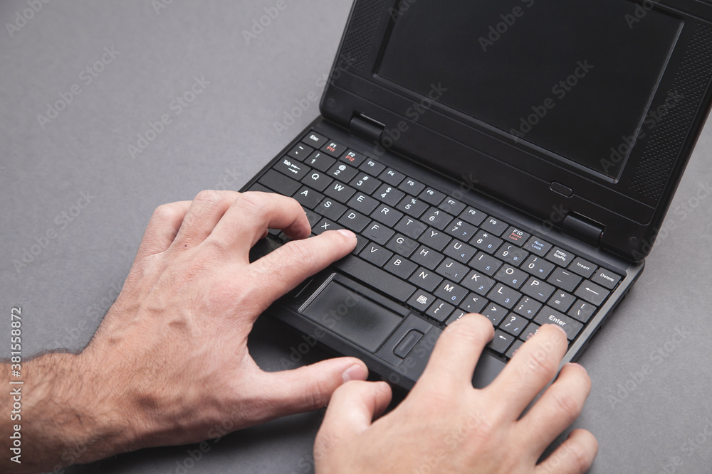 Male hands typing on computer keyboard. Male hands typing on computer keyboard.