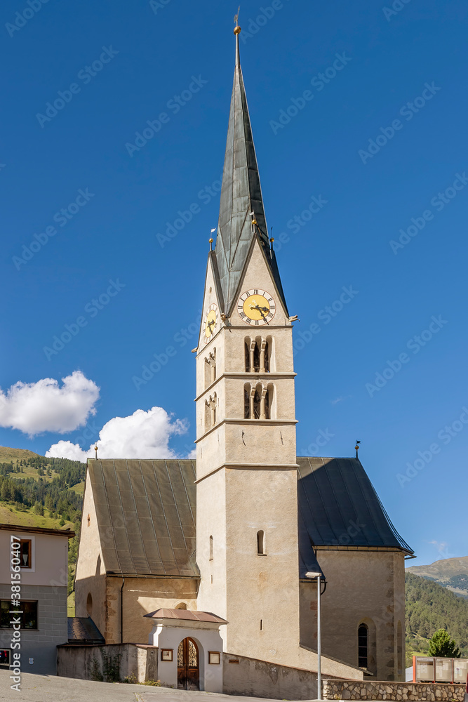 The exterior of the Evangelical Church Reformierte Kirche in Santa Maria Val Müstair, Switzerland, on a sunny day