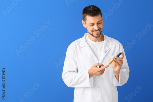 Doctor with lancet pen on c...
