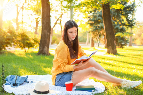 Young woman reading a book ...