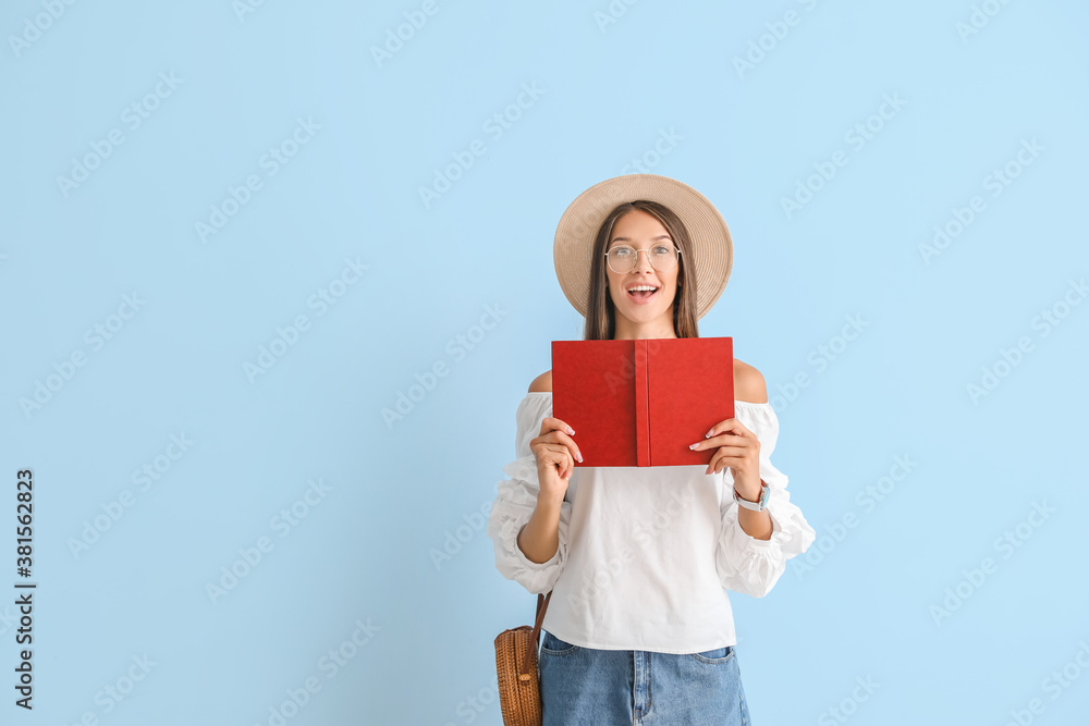 Beautiful young woman with book on color background Beautiful young woman with book on color background