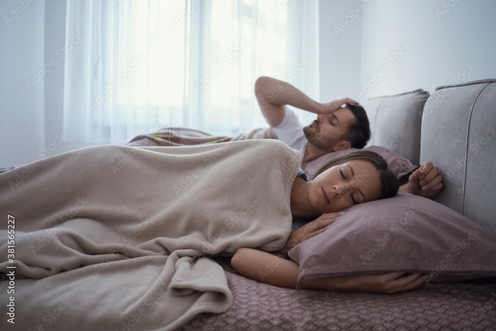 Young couple is lying in bed and waking up in the morning. Young couple is lying in bed and waking up in the morning.