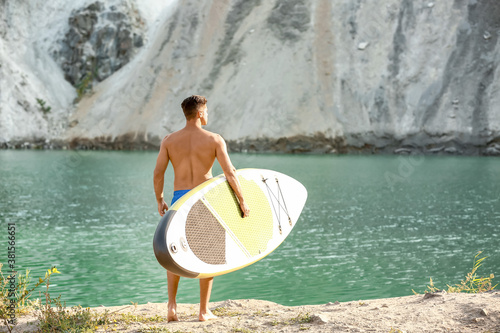 Young man with board for su...