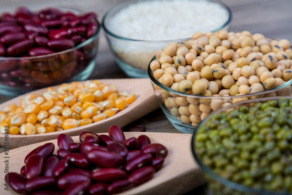 Soybean or soya bean in a bowl on wooden background. Soybeans with spoon and blow. Soybean organic background. Soybean or soya bean in a bowl on wooden background. Soybeans with spoon and blow. Soybean organic background.