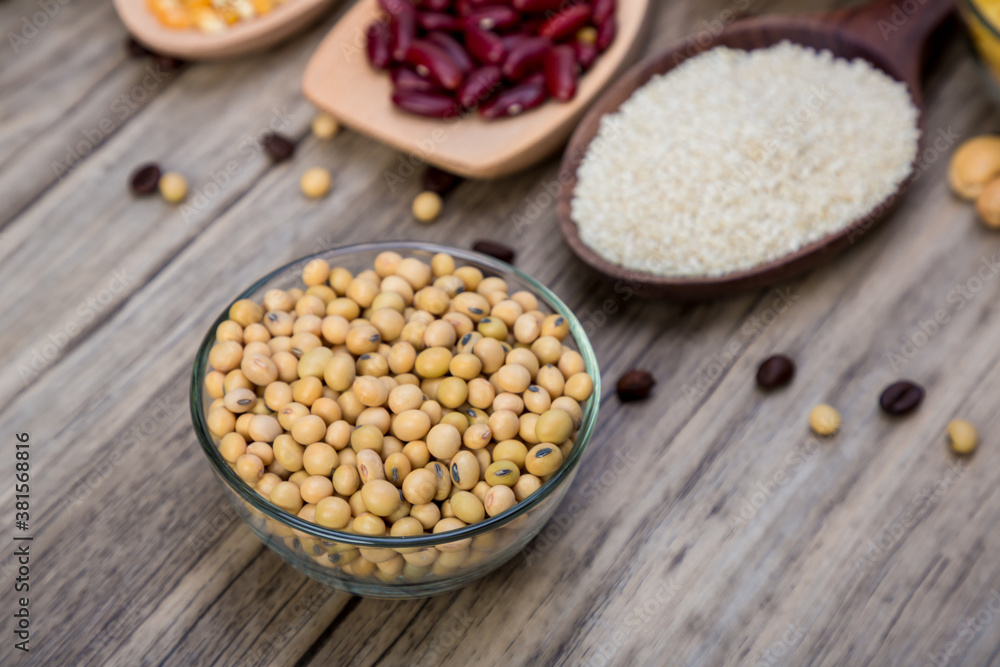 Soybean or soya bean in a bowl on wooden background. Soybean organic background. Soybean or soya bean in a bowl on wooden background. Soybean organic background.