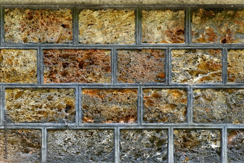 Fototapeta Naklejka Na Ścianę i Meble -  A wall made up of bricks looks like spoiled ice cream in containers got attacked by fungus and bacteria