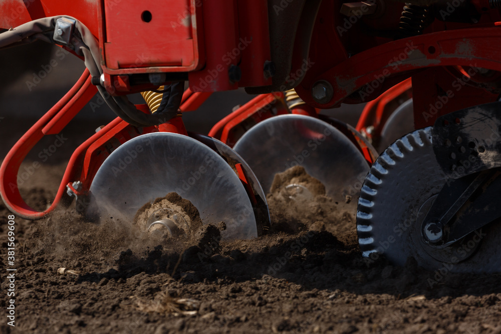 Sowing machine close up. Seeding crop with dry fertilizer. Disc coulters. Sowing machine close up. Seeding crop with dry fertilizer. Disc coulters.