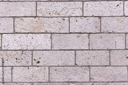 A grey bricked rectangular wall