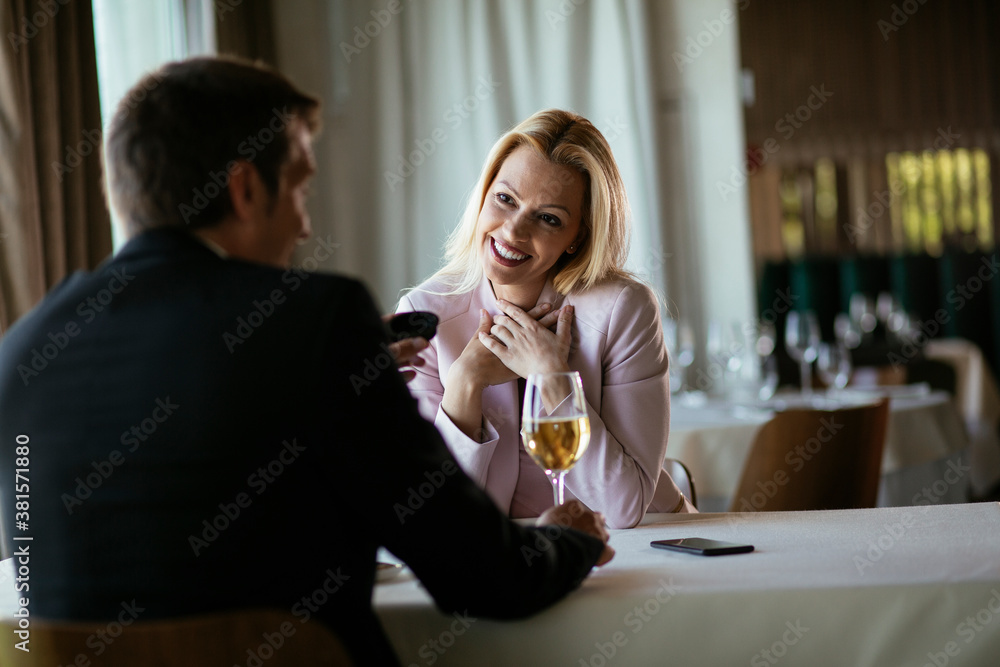 Beautiful businesswoman dressed in the suit drinking wine. Businesswoman enjoying in the restaurant..