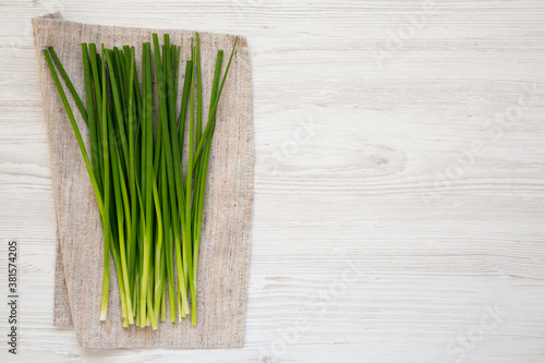 Raw Green Onions on a white wooden background  top view. Flat lay  overhead  from above. Copy space.