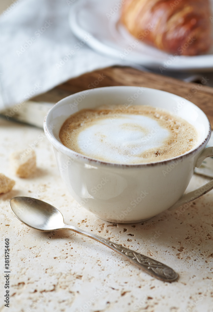 Coffee with milk on bright stone background. Close up. Coffee with milk on bright stone background. Close up.