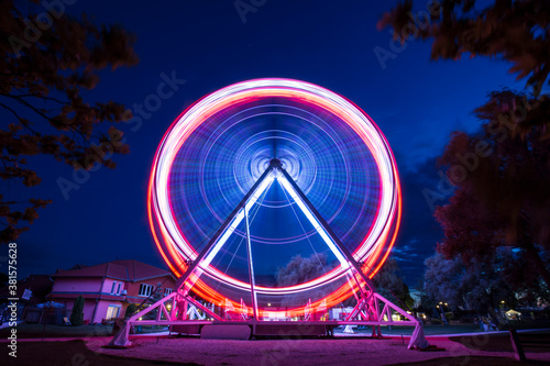 Fototapeta Ferris wheel go around at Lake Balaton at night
