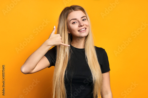 Portrait of her she nice-looking attractive lovely pretty glamorous cheerful gray-haired woman showing phone sign call me isolated on bright vivid shine vibrant yellow color background
