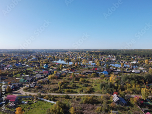 Autumn top view of a small settlement with a pond