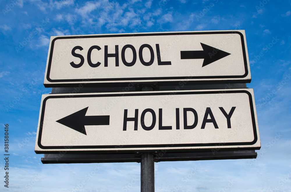 School vs holiday. White two street signs with arrow on metal pole with word. Directional road. Crossroads Road Sign, Two Arrow. Blue sky background. Two way road sign with text. School vs holiday. White two street signs with arrow on metal pole with word. Directional road. Crossroads Road Sign, Two Arrow. Blue sky background. Two way road sign with text.