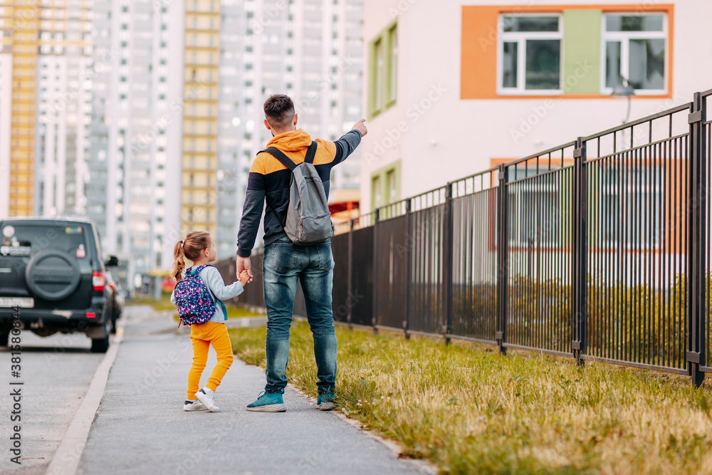 Father and daughter going to school for the first time. Back to school after pandemic.