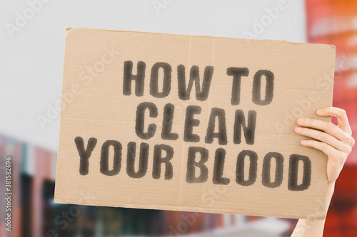 The phrase " How to Clean Your Blood " on a banner in men's hand with blurred background. Vessels. Heart. Cardiology. Cholesterol. Fat. Dangerous. Anxiety © AndriiKoval