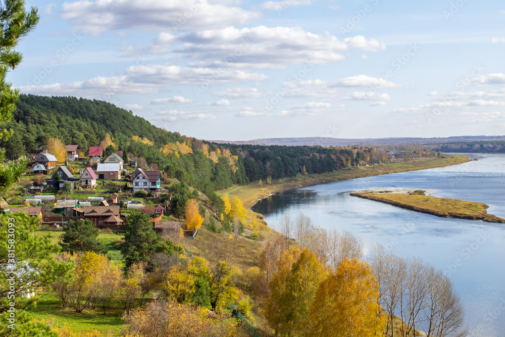 Houses along a beautiful, wide river in the middle of the forest. Houses along a beautiful, wide river in the middle of the forest.