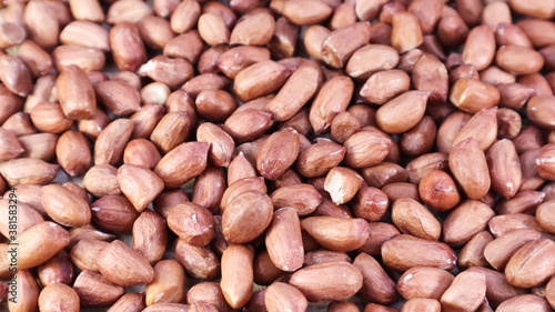 Heap of raw peanuts. Cultivated peanuts, underground or groundnuts. Plant of the legume family. Agricultural crop on an industrial scale. South America is considered the birthplace of peanuts.