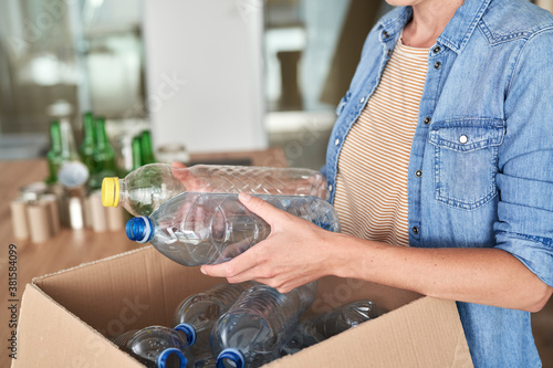 Unrecognizable woman holding plastic bottles for recycling