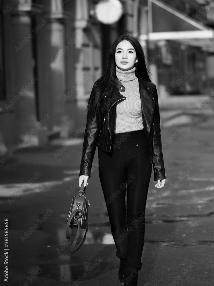 Girl walking at street city bw