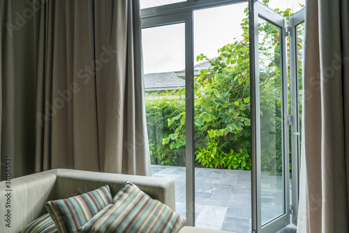 Open window in tropical villa. Summer garden  view outdoor