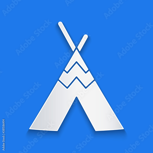 Paper cut Traditional indian teepee or wigwam icon isolated on blue background. Indian tent. Paper art style. Vector.