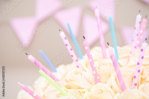 Cream pastel rose with holiday candles on a celebrating craft background