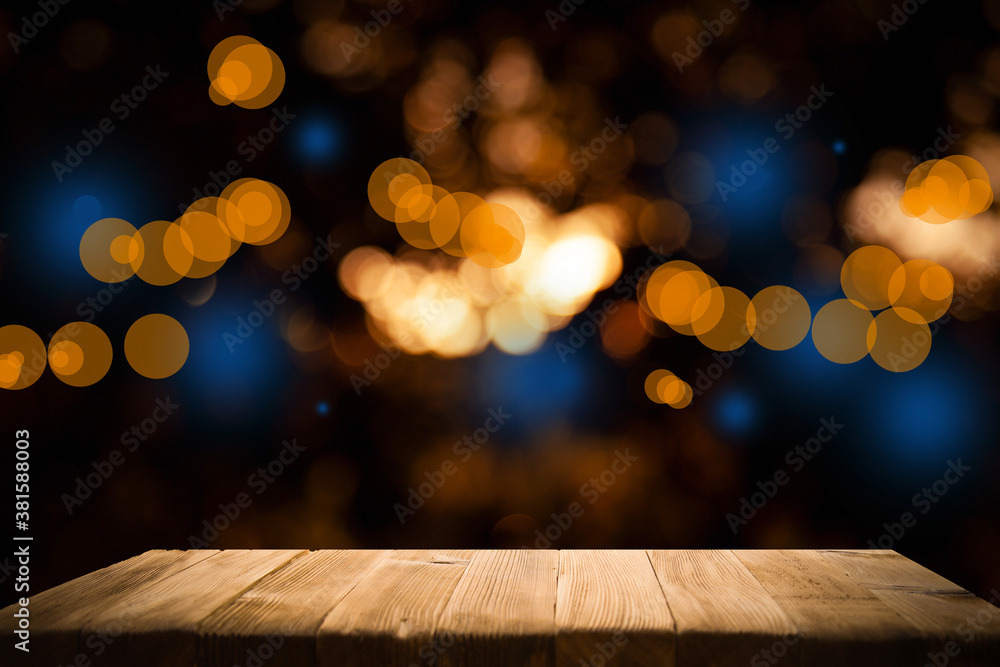 © Egor - Vintage wooden table on blurred gold bokeh against a dark background. Cafe-bar, dining-restaurant. The place is empty. © Egor - Vintage wooden table on blurred gold bokeh against a dark background. Cafe-bar, dining-restaurant. The place is empty.