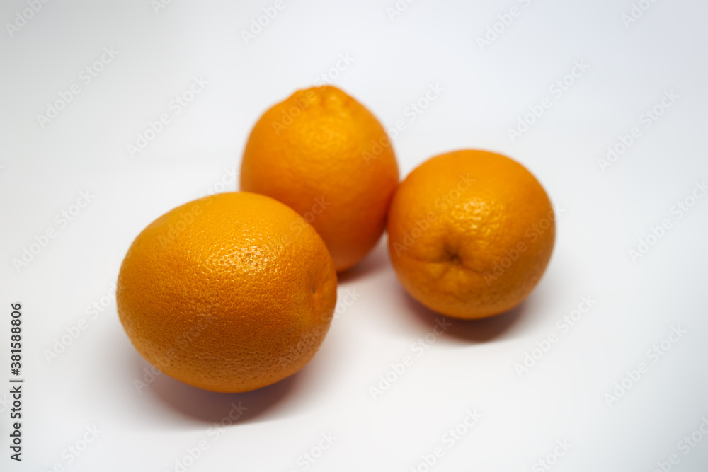 Photo of three oranges on a white background Photo of three oranges on a white background