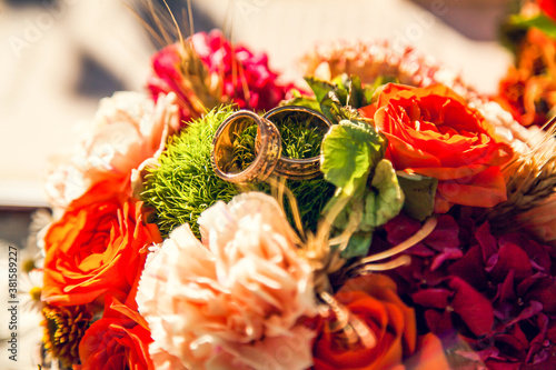 Wedding rings on the bride s bouquet in the autumn theme