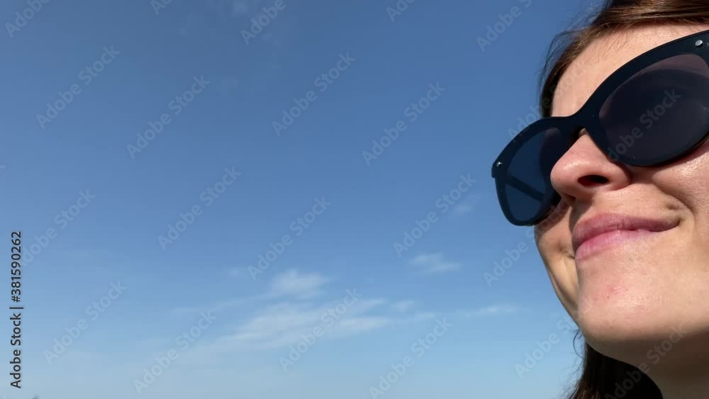 Young woman in sunglasses closeup portrait with a beautiful sky background. Young woman in sunglasses closeup portrait with a beautiful sky background.