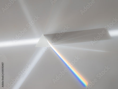 Scattering of a ray of sunlight  white light  through a prism creating refraction  reflection and decomposition of light in the colors of the rainbow